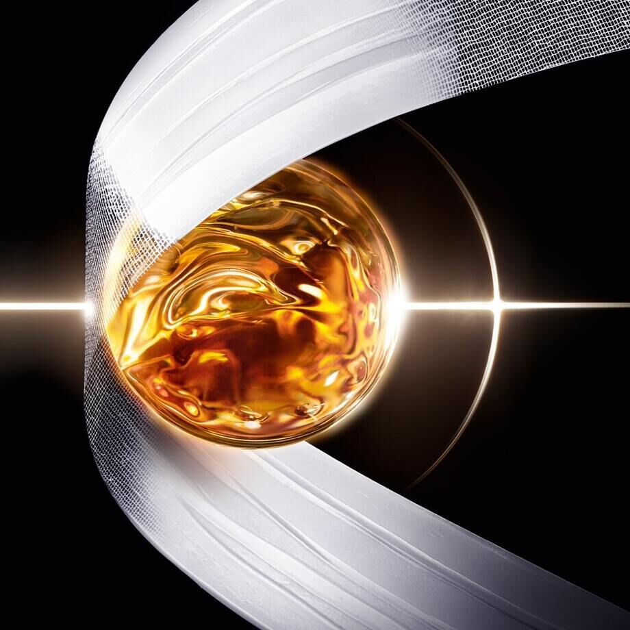 A golden orb surrounded by a flowing ribbon, with a bright light shining from behind, creating a dramatic effect.
